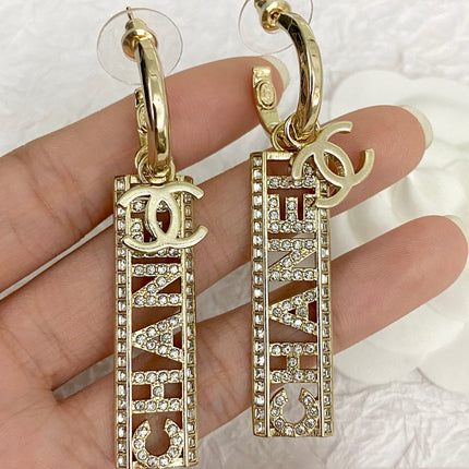 CC TEXT DIAMOND PAVED LIGHT GOLD DROP EARRINGS