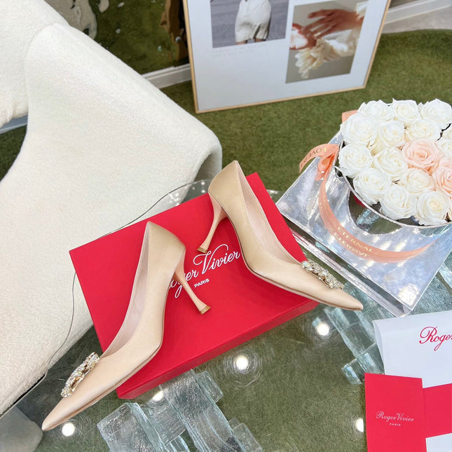 EFFLORESCENCE POINTED-TOE PUMPS IN NUDE SATIN WITH CRYSTAL BUCKLE