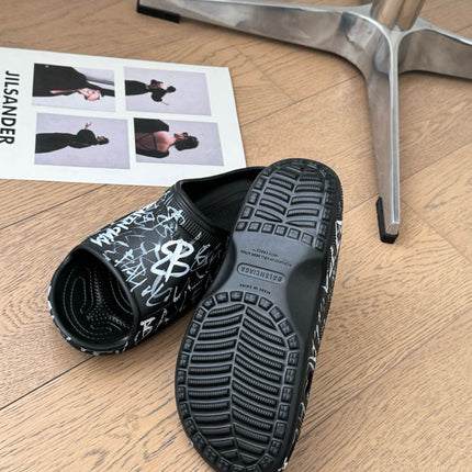 POOL GRAFFITI CROCS SLIDE SANDALS IN BLACK AND WHITE RUBBER