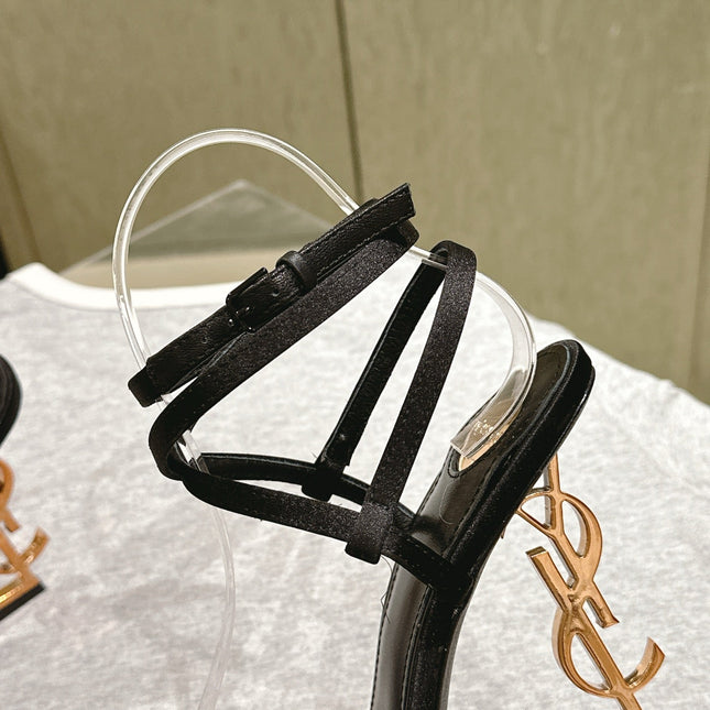 YSL 25S HIGH-HEEL SANDALS 100 MM IN BLACK SATIN WITH YSL LOGO HEEL DESIGN IN GOLD