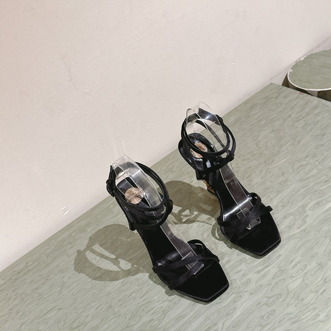 YSL 25S HIGH-HEEL SANDALS 100 MM IN BLACK SATIN WITH YSL LOGO HEEL DESIGN IN GOLD