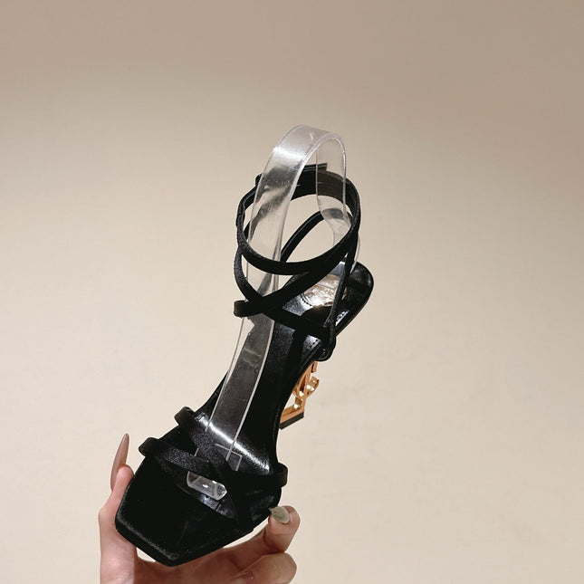 YSL 25S HIGH-HEEL SANDALS 100 MM IN BLACK SATIN WITH YSL LOGO HEEL DESIGN IN GOLD