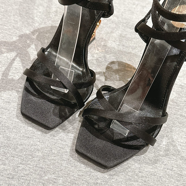 YSL 25S HIGH-HEEL SANDALS 100 MM IN BLACK SATIN WITH YSL LOGO HEEL DESIGN IN GOLD