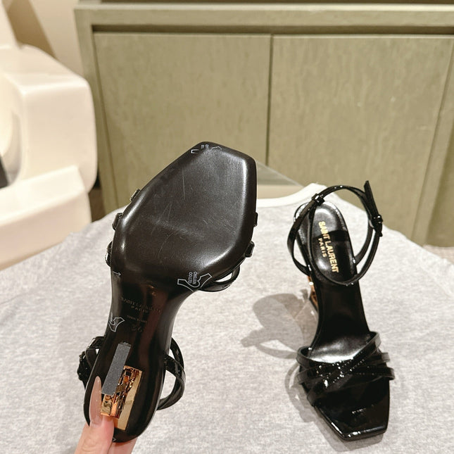 YSL 25S HIGH-HEEL SANDALS 100 MM IN BLACK GLOSSY LAMBSKIN WITH YSL LOGO HEEL DESIGN IN GOLD