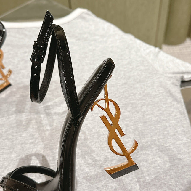 YSL 25S HIGH-HEEL SANDALS 100 MM IN BLACK GLOSSY LAMBSKIN WITH YSL LOGO HEEL DESIGN IN GOLD