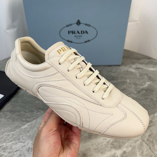PRADA 25S MONTECARLO ANTIQUED SNEAKERS IN CHALK WHITE NAPPA LEATHER