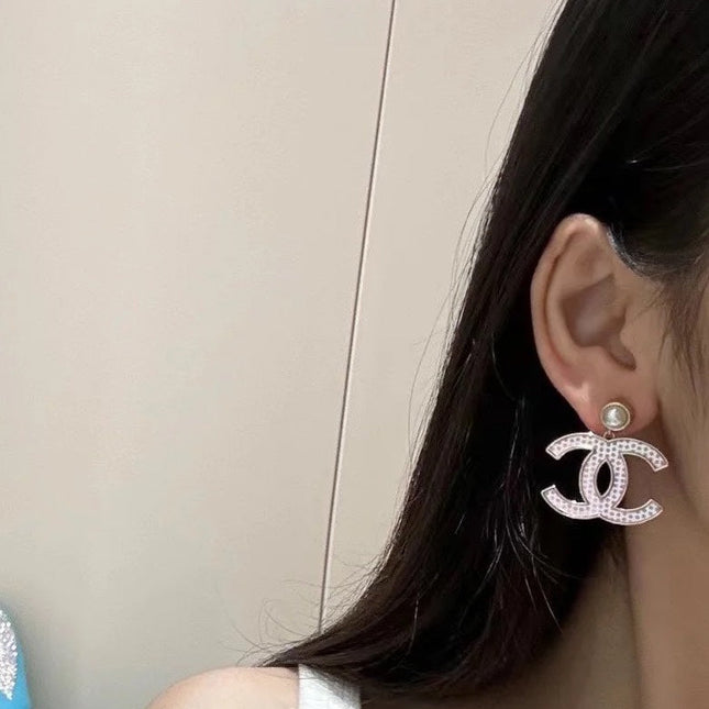 DOUBLE C EARRINGS IN SILVER METAL WITH BLACK SNOWFLAKE EMBOSSED ON WHITE ENAMEL