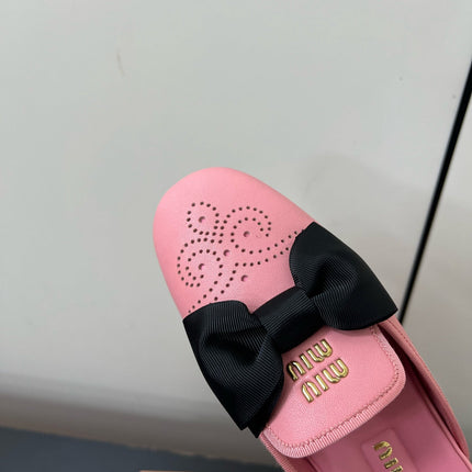 BOW MULES IN PINK SHEEPSKIN