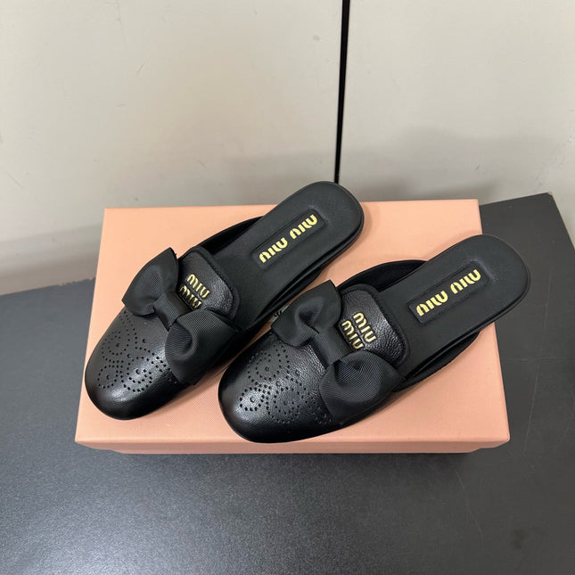 BOW MULES IN BLACK SHEEPSKIN