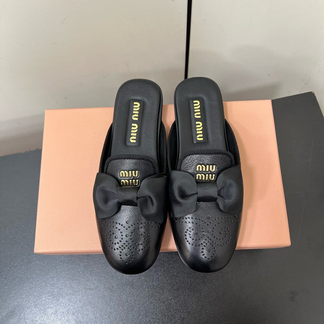 BOW MULES IN BLACK SHEEPSKIN