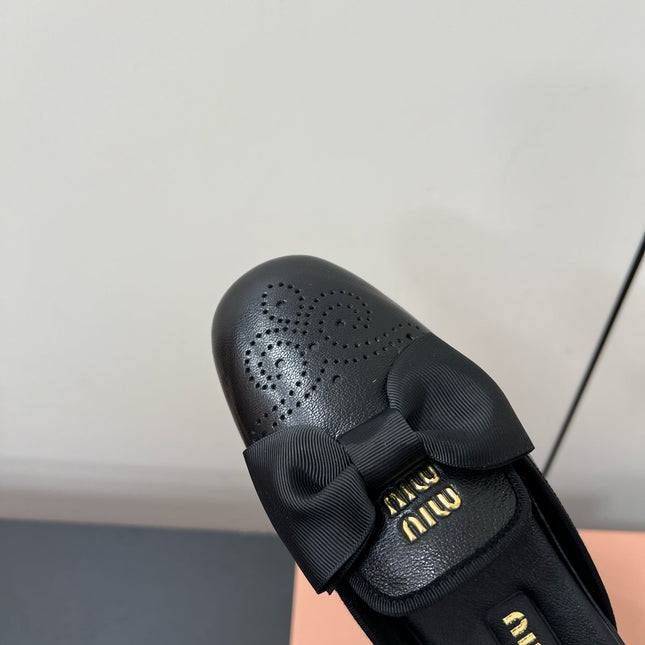 BOW MULES IN BLACK SHEEPSKIN