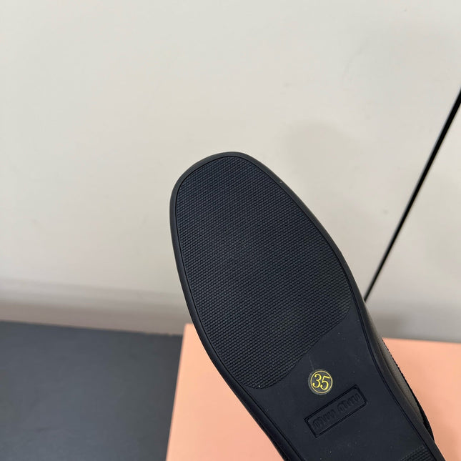 BOW MULES IN BLACK SHEEPSKIN