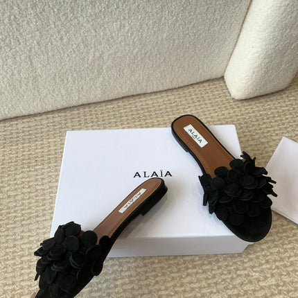ALAIA FLAT MULE IN BLACK SUEDE
