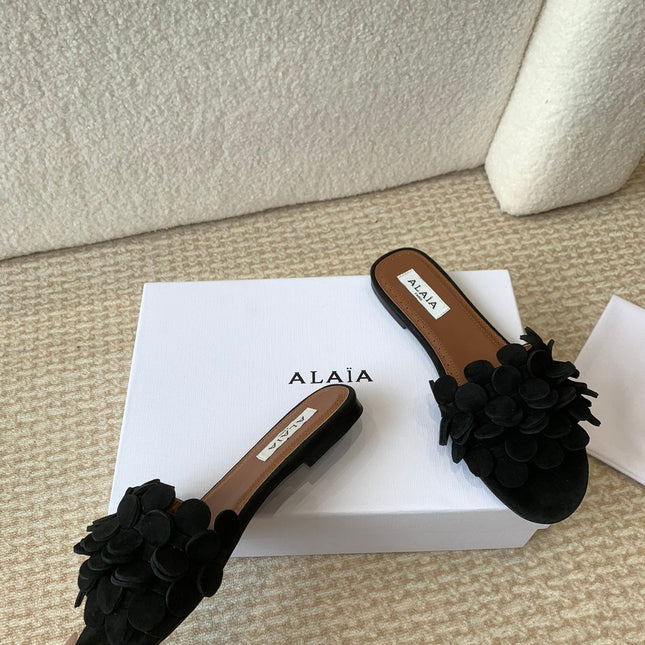 ALAIA FLAT MULE IN BLACK SUEDE