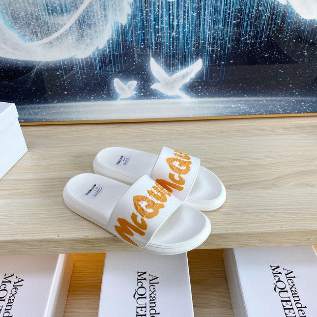 SLIDES SANDAL IN WHITE TPU WITH BOLD ORANGE LOGO GRAPHIC IN STRAP