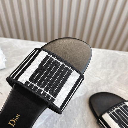 DIOR FLAT SLIDES 25S IN BLACK CALFSKIN AND FABRIC BRAND NAME EMBROIDERY