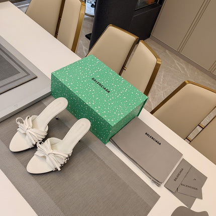 BOW-EMBELLISHED HIGH MULES IN WHITE SHEEPSKIN