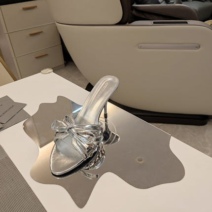 BOW-EMBELLISHED HIGH MULES IN SILVER METALLIC SHEEPSKIN