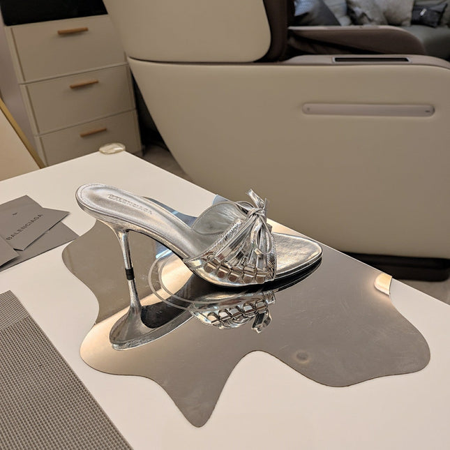 BOW-EMBELLISHED HIGH MULES IN SILVER METALLIC SHEEPSKIN