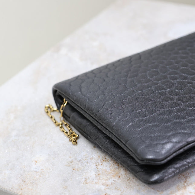 CALYPSO POUCH 24 IN BLACK ELEPHANT TEXTURED LAMBSKIN GOLD LOGO