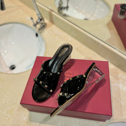 ROCKSTUD MULE SANDALS WITH TRANSPARENT HEEL IN BLACK CALFSKIN