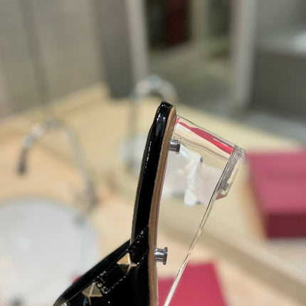ROCKSTUD MULE SANDALS WITH TRANSPARENT HEEL IN BLACK CALFSKIN