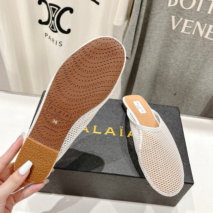 ALAIA FLAT MULES IN WHITE MESH FISHNET