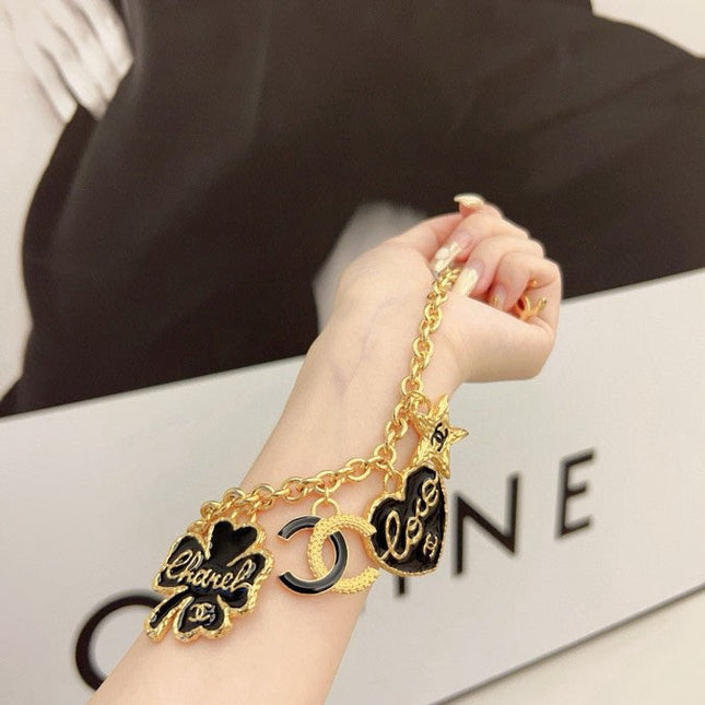 CC BRACELET IN GOLD PLATING CHAIN WITH MULTI CHARM