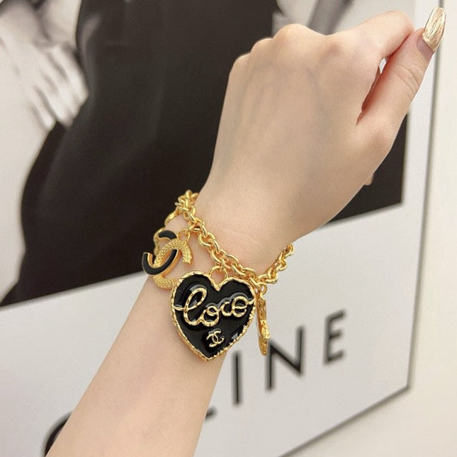CC BRACELET IN GOLD PLATING CHAIN WITH MULTI CHARM