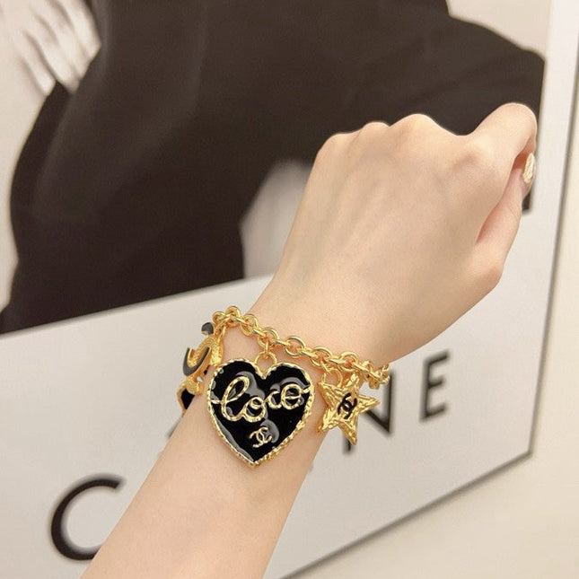 CC BRACELET IN GOLD PLATING CHAIN WITH MULTI CHARM